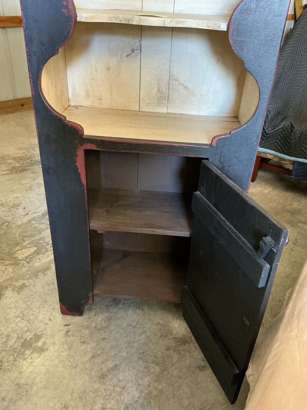 Scalloped wall cupboard in black over red