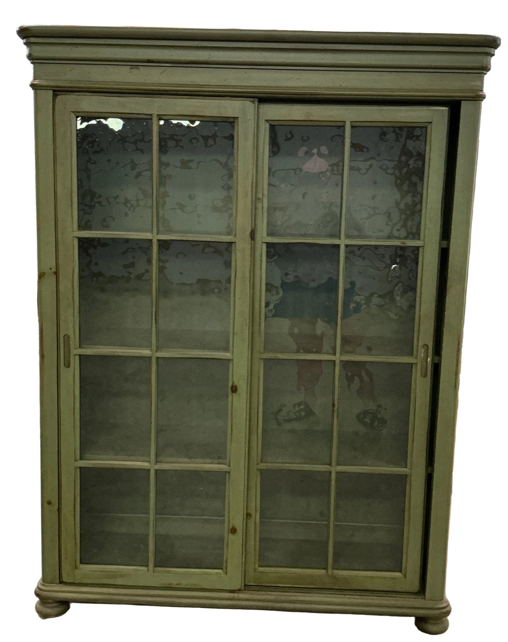Green bookcase/display cupboard with 2 sliding doors.