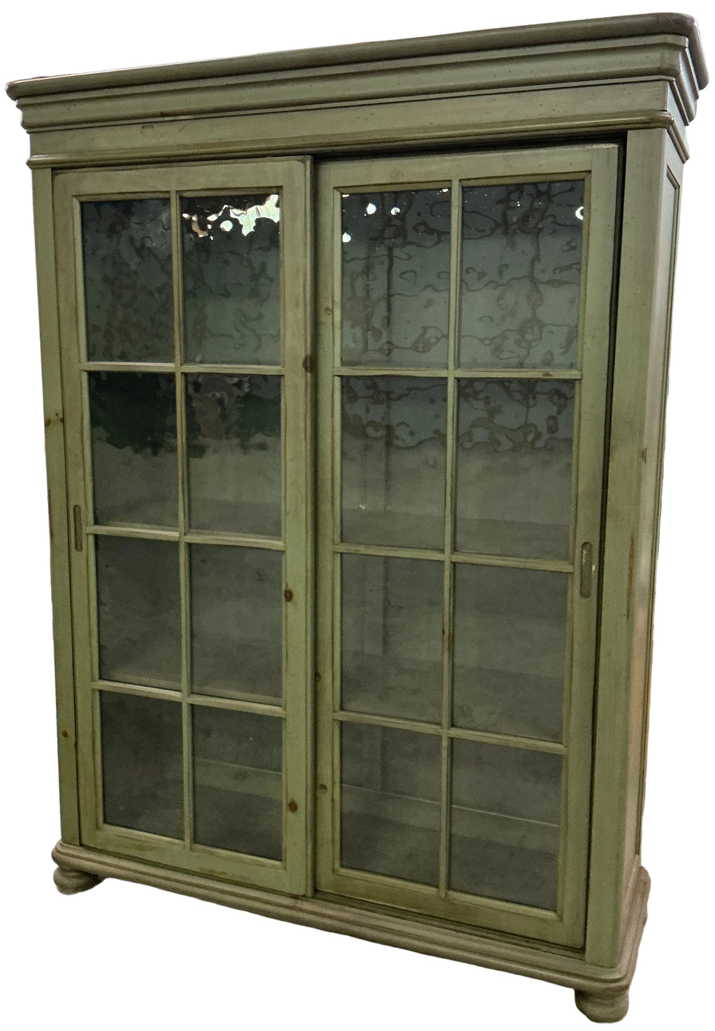 Green bookcase/display cupboard with 2 sliding doors.