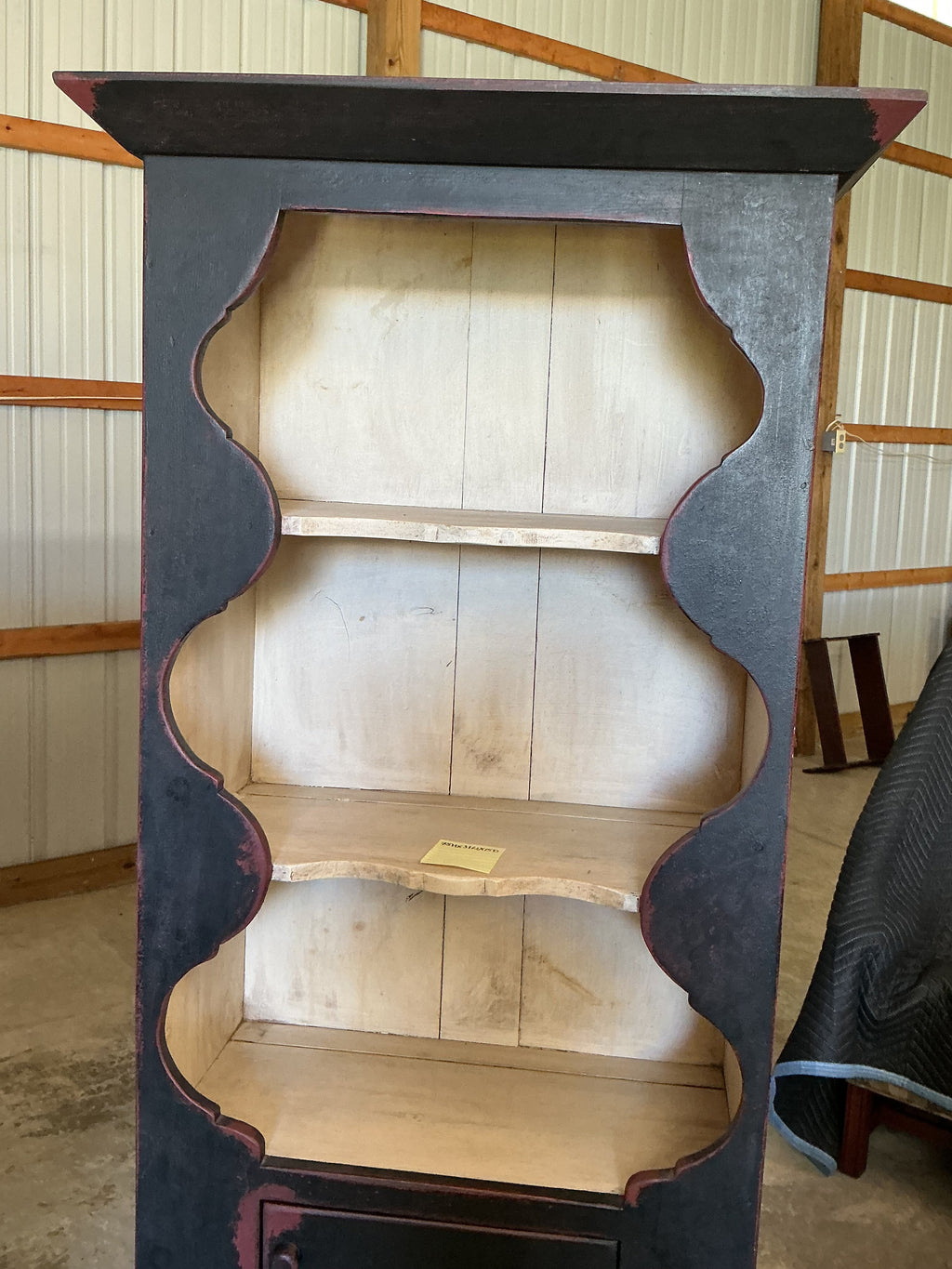 Scalloped wall cupboard in black over red